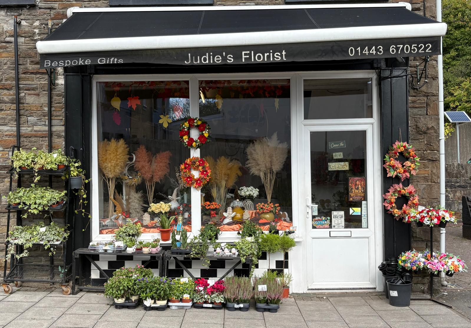 The front of Judie’s Florist in Tonyrefail, decorated with flowers and plants